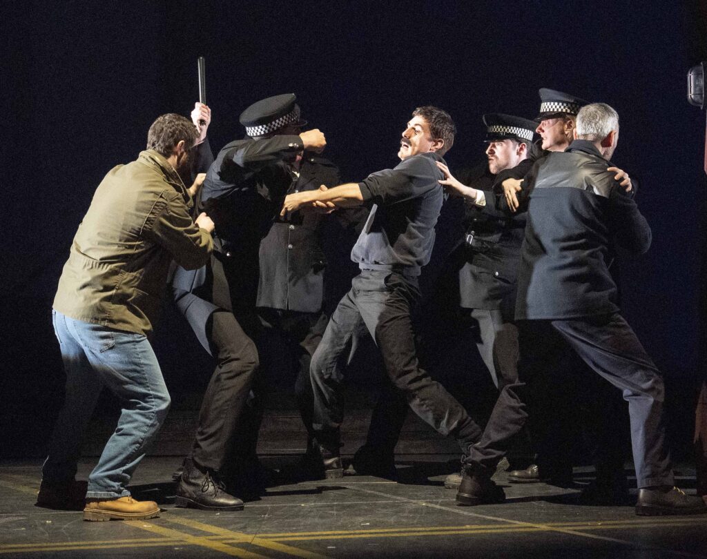 The 2025 Tour Cast of Boys from the Blackstuff - Police on stage trying to catch Yosser. Dixie and Todd trying to pull them back.