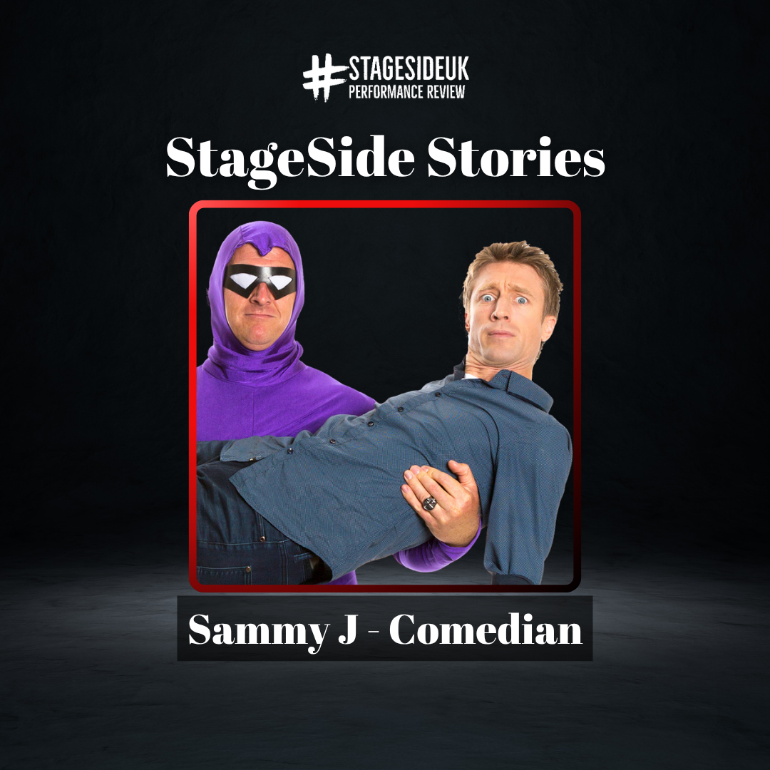 Comedian Sammy J being held by a masked hero in a purple costume.