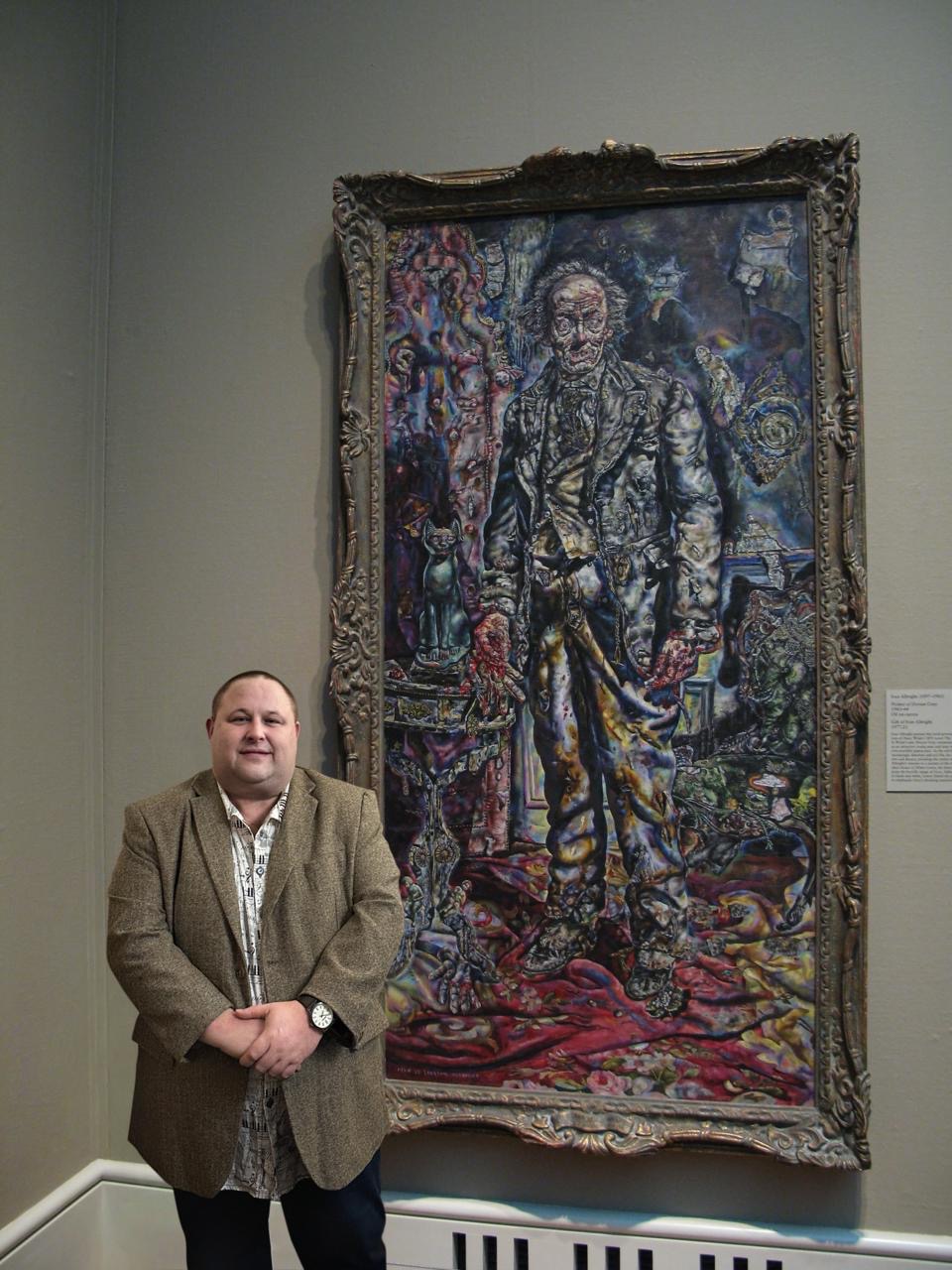 Mark Middlemiss in an art gallery infront of a painting